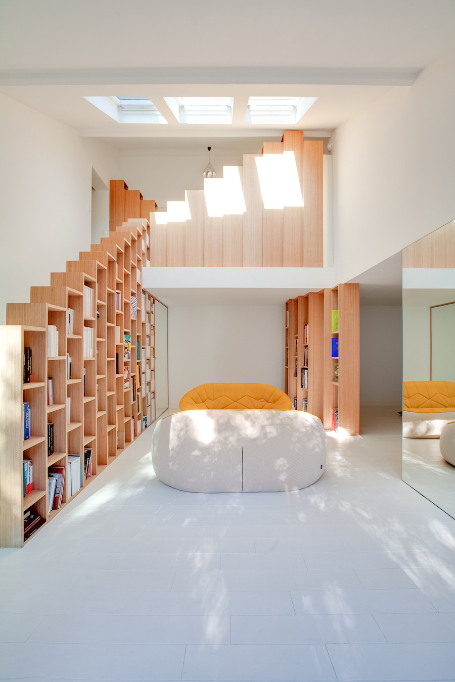 A Stunning, Bright Home in Paris by Andrea Mosca with a staircase bookshelf